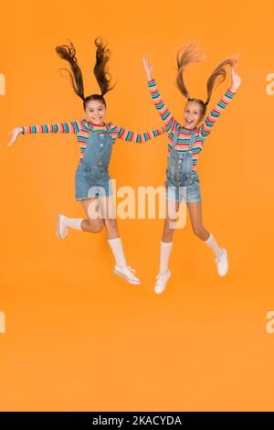 Emotional kids. Fashion shop. Must have accessory. Modern fashion. Kids  fashion. Girls long hair. Cute children same outfits. Trendy and fancy.  Little girls wearing rainbow clothes. Happiness Photos