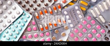 Bunch of pills of different colors in blisters pack, closeup. Medicine drug of various shape. Pharmacy tablets and vitamins for treatment health, back Stock Photo