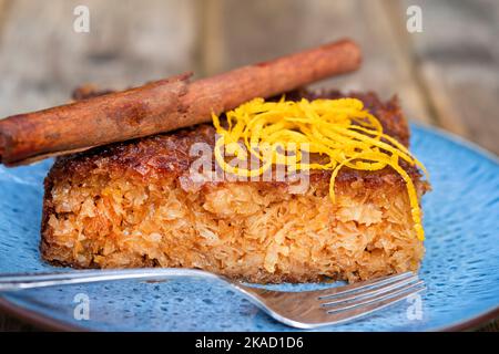 A serving or slice of Orange Pie. This is a Greek speciality known as Portokalopita. Its made with phyllo pastry and soaked in an orange syrup Stock Photo