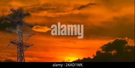 High-voltage tower with electric wires in the rays of sunset. High voltage tower Electric wires. Solar rays. Evening sunset. background image. Templat Stock Photo