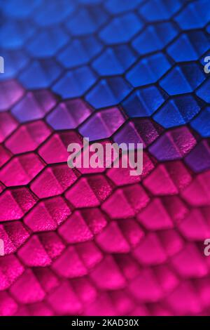 Abstract geometric background of hexagonal cells with blue-crimson highlights and shallow depth of field Stock Photo