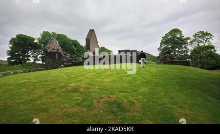 2019 photo -  Distant view of St Blane's Church, Isle of Bute, Scotland. Saint Blane or Bláán was an early Scottish  Christian Pictish bishop  who was born at some unknown date on the Isle of Bute. He died 590 AD . His feast day is the  10th August. He is recognised also by the Scottish Episcopal Church, the  Roman Catholic Church and the Eastern Orthodox Church. The double burial ground is said to be for males and females, though other authorities think the upper one was for monks whilst the lower one was for the laity. St Blane is said to be buried in the upper graveyard. Stock Photo