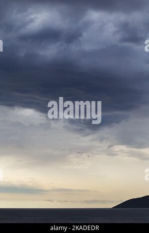 Raining at sea, Dramatic dark blue grey rain clouds hover over the ...