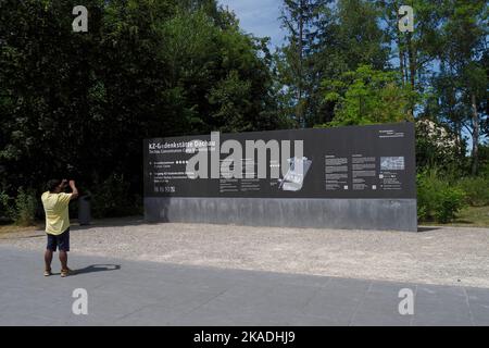 a tourist at the entrance sign to Dachau concentration camp,Bavaria,Germany,Europe Stock Photo
