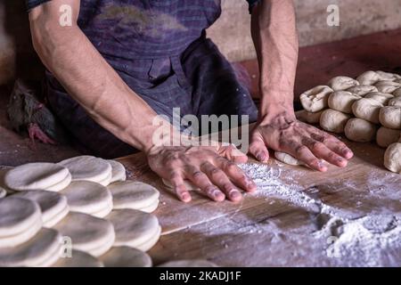 Hands of a man preparing dough for bread in Leh, Ladakh, India Stock Photo