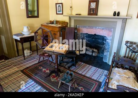 Antique furnishings including a spinning wheel in a lodging room of the Cove Creek Ranch Fort, built in 1867, Cove Fort, Utah. Stock Photo