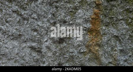The texture of an old stone. Grey aged rusty background. Horizontal banner for design. The gray-brown texture of a battered stone. Construction produc Stock Photo