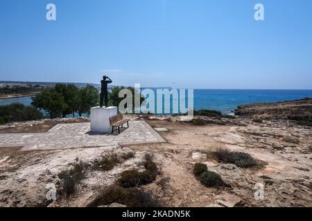 Ayia Napa, Cyprus - June 24, 2022:  Man with binoculars observer sculpture at the view point next to Vathia Gonia beach. Stock Photo