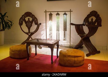 Wooden table with two wooden armchairs next to it in a hotel Stock Photo