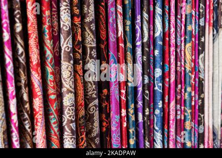 Oriental, Turkish, Indian multi-colored women's silk headscarves handmade on shop window for sale Stock Photo