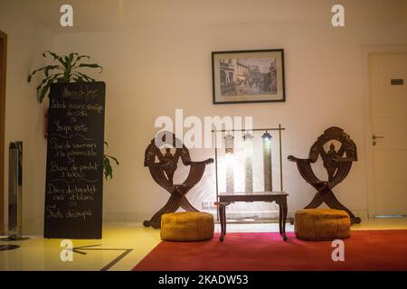 Wooden table with two wooden armchairs next to it in a hotel Stock Photo