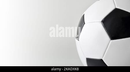Macro detail of classic leather stitched soccer ball with gray isolated background Stock Photo