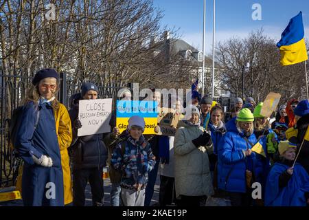 Reykjavik, Iceland - March 13, 2022: People carrying ukrainian colours and banners, protesting against war in Ukraine. Stock Photo