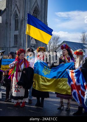 Reykjavik, Iceland - March 13, 2022: People carrying ukrainian colours and banners, protesting against war in Ukraine. Stock Photo