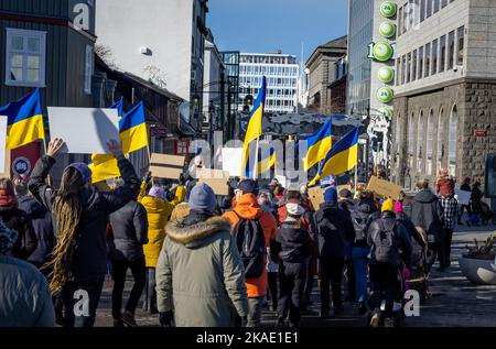 Reykjavik, Iceland - March 13, 2022: People carrying ukrainian colours and banners, protesting against war in Ukraine. Stock Photo