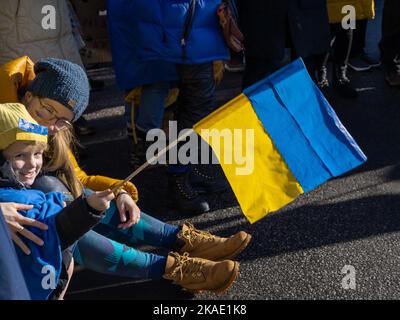 Reykjavik, Iceland - March 13, 2022: People carrying ukrainian colours and banners, protesting against war in Ukraine. Stock Photo