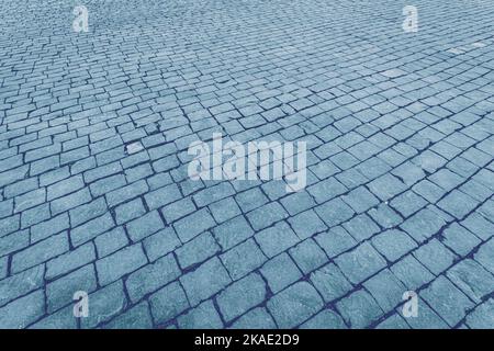 Top view on paving stone road. Old pavement of granite texture. Street cobblestone sidewalk. Abstract background for design. Stock Photo
