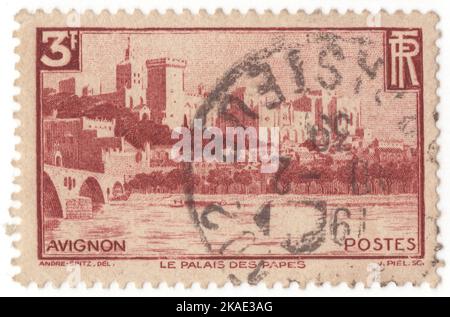 FRANCE - 1938: An 3 francs carmine-brown postage stamp depicting panorama on Palace of the Popes (Palais des Papes), is a historical palace located in Avignon, Southern France. It is one of the largest and most important medieval Gothic buildings in Europe. Once a fortress and palace, the papal residence was a seat of Western Christianity during the 14th century. Since 1995, the Palais des Papes has been classified, along with the historic center of Avignon, as a UNESCO World Heritage Site, for its outstanding architecture and historical importance for the Papacy Stock Photo