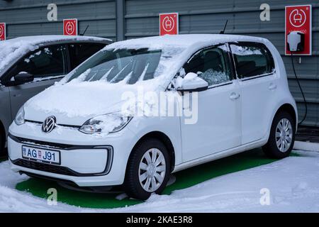 Reykjavik, Iceland - January 25, 2022: A new electric Volkswagen E-up! car charging at the outdoor parking in winter. Stock Photo