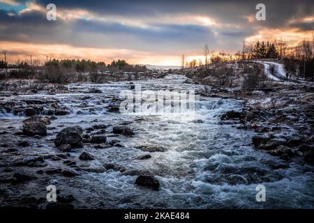 Winter sunset over the Ellidaa river in Reykjavik, Iceland. Stock Photo