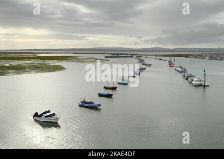 Moored Boats On Lymington River Entrance Looking Across The Solent To Yarmouth And The Isle Of Wight, Lymington UK Stock Photo