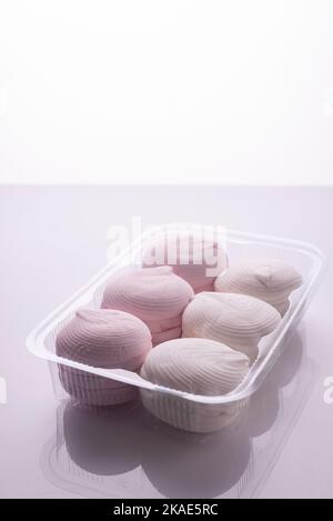 pink and white marshmallows packed on a white background. Stock Photo
