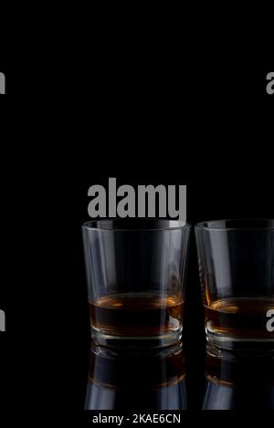 glasses with whiskey on a black background Stock Photo