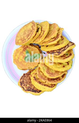 closeup the bunch yellow brown bengal gram fried food with green mint in the plate on the white background. Stock Photo