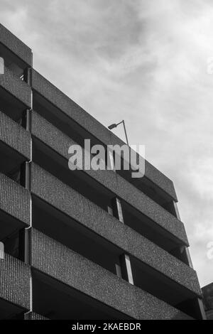 Black and white image of a section of a UK multi-storey car park/parking garage. Stock Photo