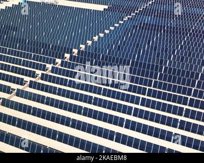 An array of polycrystalline silicon solar cells in solar power plant turned up skyward Stock Photo