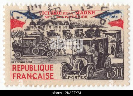 FRANCE - 1964 September 5: An 30 centimes black, blue and red postage stamp depicting Paris Taxis Carrying Soldiers to Front, 1914. 50th anniversary of Battle of the Marne Stock Photo