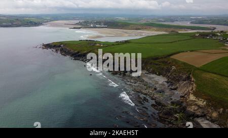 Stone cliffs on the south coast of Ireland, County Cork. Beautiful seaside landscape, top view. Farm fields on the hills. Patchwork landscape. Aerial Stock Photo