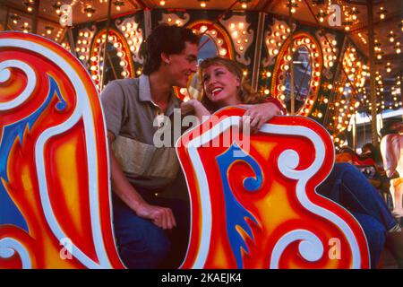 Young couple on ride at funfair. Luna Park. Sydney. Stock Photo