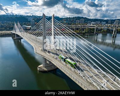 Tilikum Crossing, Bridge of the People is a cable-stayed bridge across the Willamette River in Portland, Oregon, United States. It was designed by TriMet, the Portland metropolitan area's regional transit authority, for its MAX Orange Line light rail passenger trains. The bridge also serves city buses and the Portland Streetcar, as well as bicycles, pedestrians, and emergency vehicles. Private cars and trucks are not permitted on the bridge. It is the first major bridge in the U.S. that was designed to allow access to transit vehicles, cyclists and pedestrians but not cars. Stock Photo