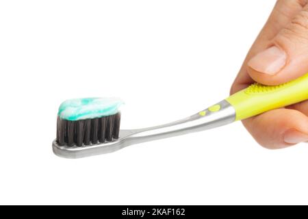 Female hand holding toothbrush with toothpaste isolated on white background. Stock Photo