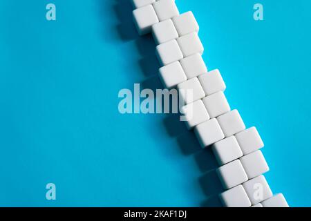 Chain of blocks on a blue background. Abstraction structure. concept of organization and strength. Unity and Consolidation. Orderly system. Stability, Stock Photo