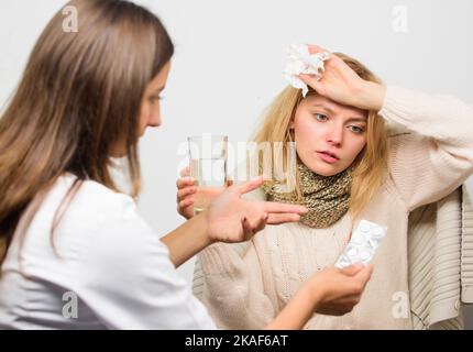 Girl in scarf hold tissue while doctor offer treatment. Cold and flu remedies. Tips how to get rid of cold. Recognize symptoms of cold. Remedies Stock Photo