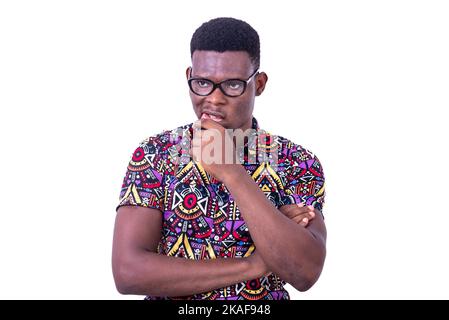 young man wearing optical glasses, thinking crosses arm and raised hand over mouth. Stock Photo