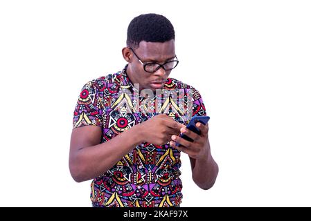 young surprised man wearing glasses, looking and pointing finger at screen of cellphone. Stock Photo