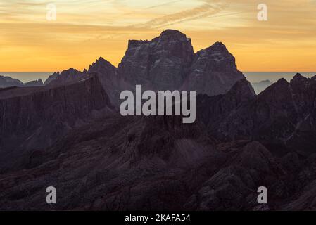 Dawn on the summit of the small Lagazuoi with the panorama of the Dolomites and peaks of Monte Pelmo, Novolau, Averau, Italy Stock Photo