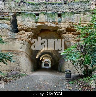 Lower entrance to Park Tunnel, showing part stone-lined wall and unlined sandstone, with shaft and upper tunnel in distance Stock Photo