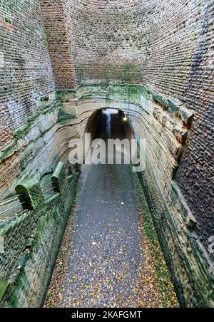 View from College Street into part stone-lined midway shaft towards unlined lower Park Tunnel, with staircase from Upper College Street Stock Photo