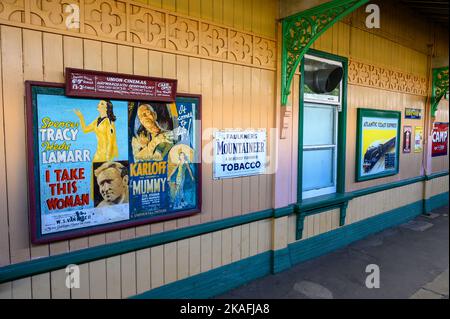 Vintage movie poster and advertising signs at Horsted Keynes station on the historic Bluebell Railway line, East Sussex, England. Stock Photo