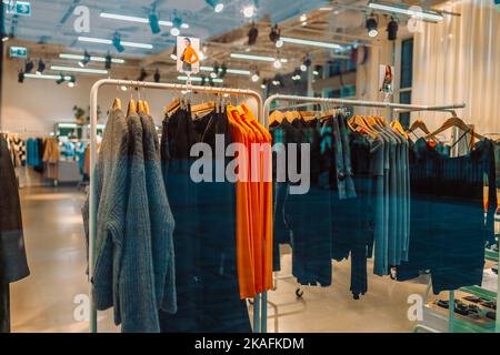 Store Of Shopping. Gdansk, Poland, Europe. Mannequins dressed in women female casual clothes in store of shopping center. Stack clothes in mall store Stock Photo