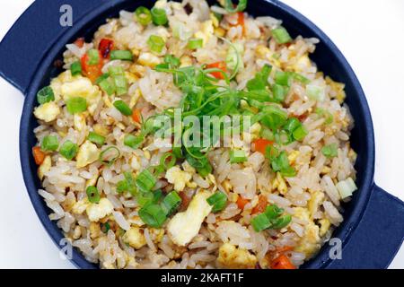 asiatic style chicken and egg stir fried rice in close up in a bowl Stock Photo
