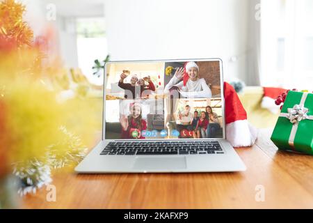 Diverse people having christmas video call on laptop screen Stock Photo