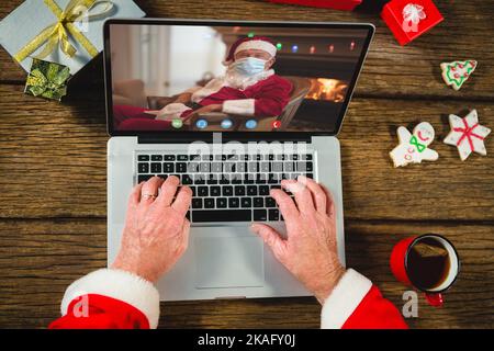 Senior caucasian man having christmas video call with senior caucasian man Stock Photo