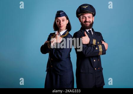 Smiling plane flight attendant showing middle finger offensive gesture ...