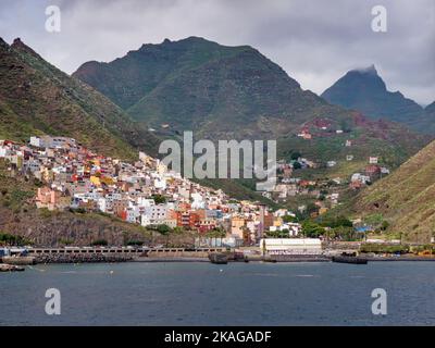 View of the small town of San Andres on the Canary Island of Tenerife from the sea. In the background the foothills of the Anaga mountains. Stock Photo