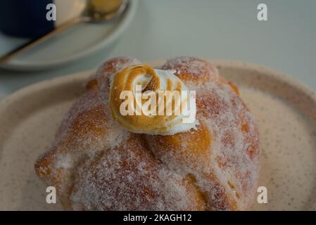 Mexican sweet bread known as pan de muerto with meringue on top Stock Photo